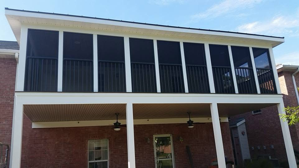Upper-story white screen enclosure above a covered brick patio