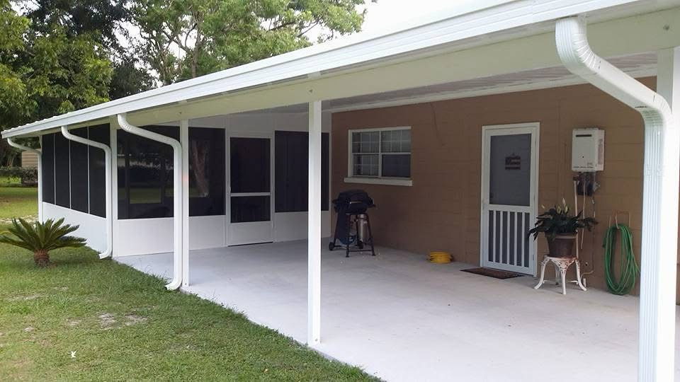 White screen room attached to a covered patio with white posts and gutters